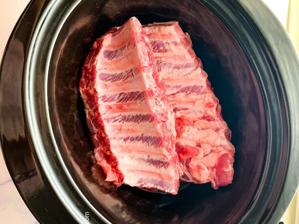 teriyaki ribs shows in the crock pot before basting with sauce