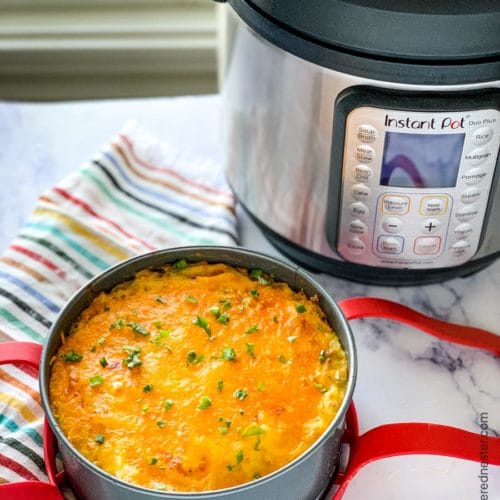 A pan of cheesy hash brown casseroles with instant pot in the background