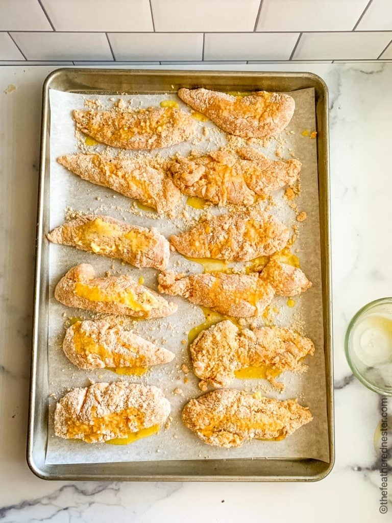 a baking sheet of bisquick oven fried chicken ready to go into the oven