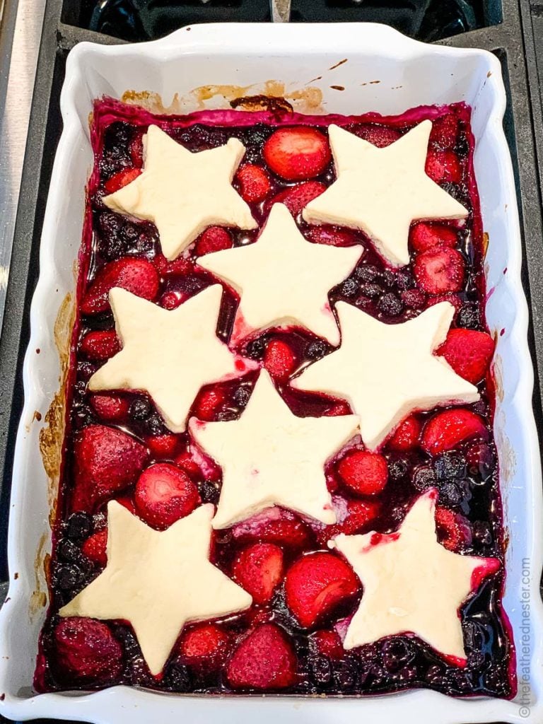 strawberry blueberry cobbler with star shaped biscuit topping