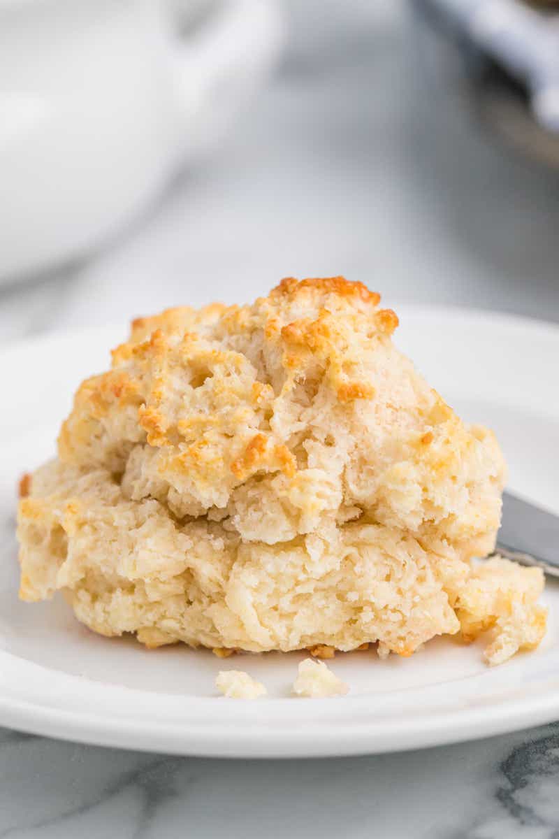 One buttermilk drop biscuit on a white plate.