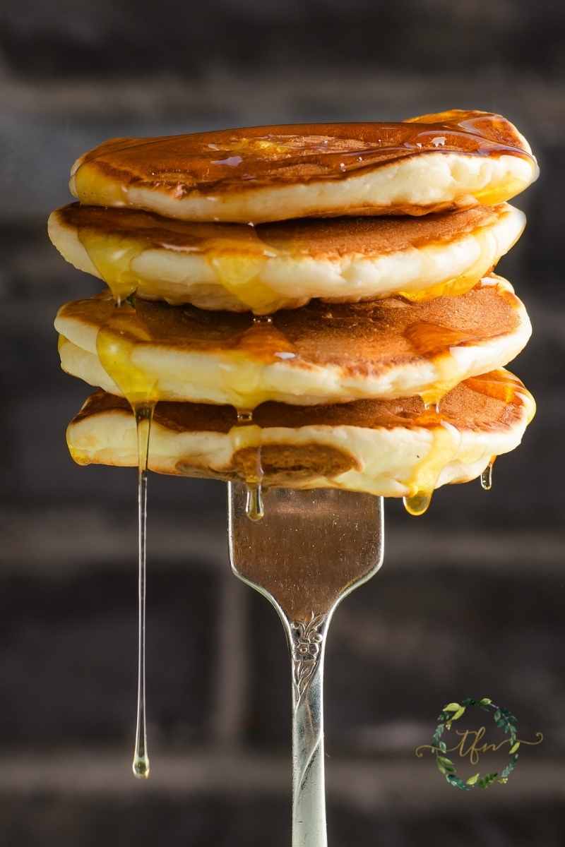 a fork holding up a stack of dollar pancakes.