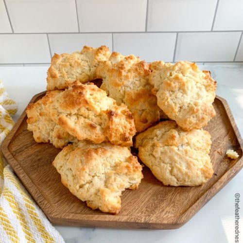 a wooden platter of drop biscuits made with Bisquick.