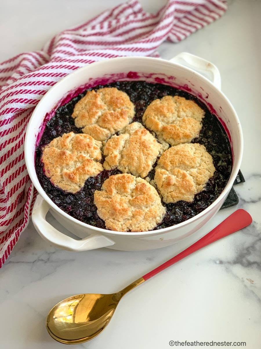 A casserole dish with freshly baked Bisquick blueberry cobbler.