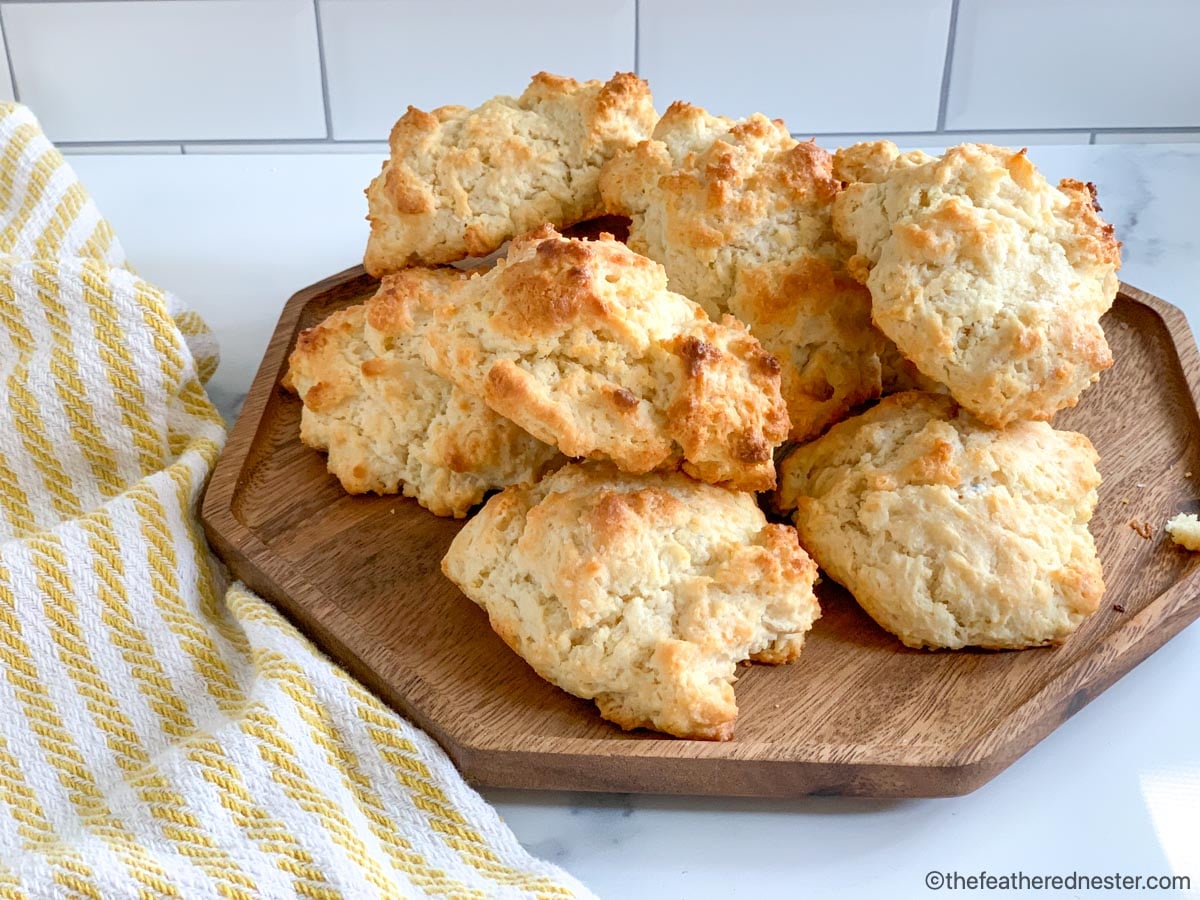 A wooden serving platter of Bisquick biscuits drop.