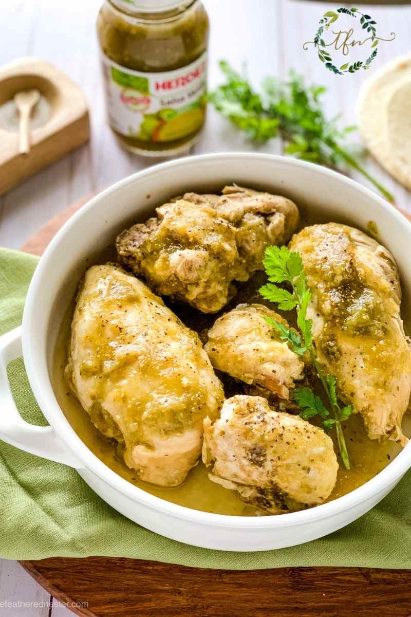 A white casserole dish of creamy Instant Pot chicken Chile verde ready to serve.