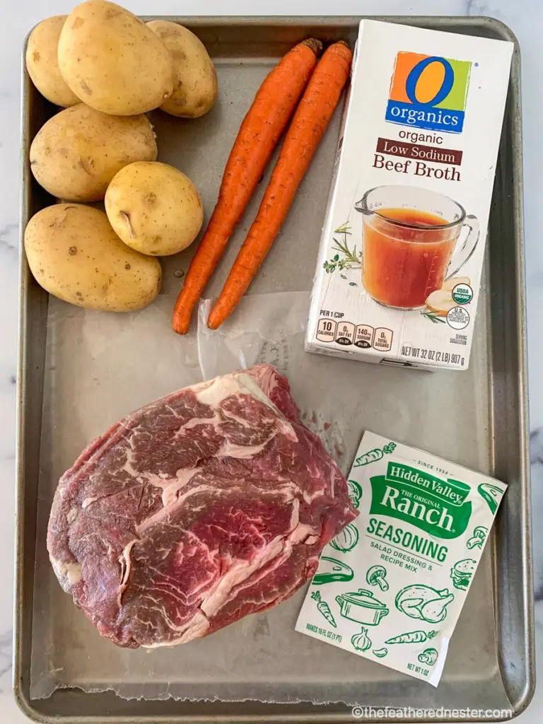 Ingredients for Crock Pot Chuck Roast: ranch seasoning mix, a chuck roast, beef beef broth, potatoes, and carrots