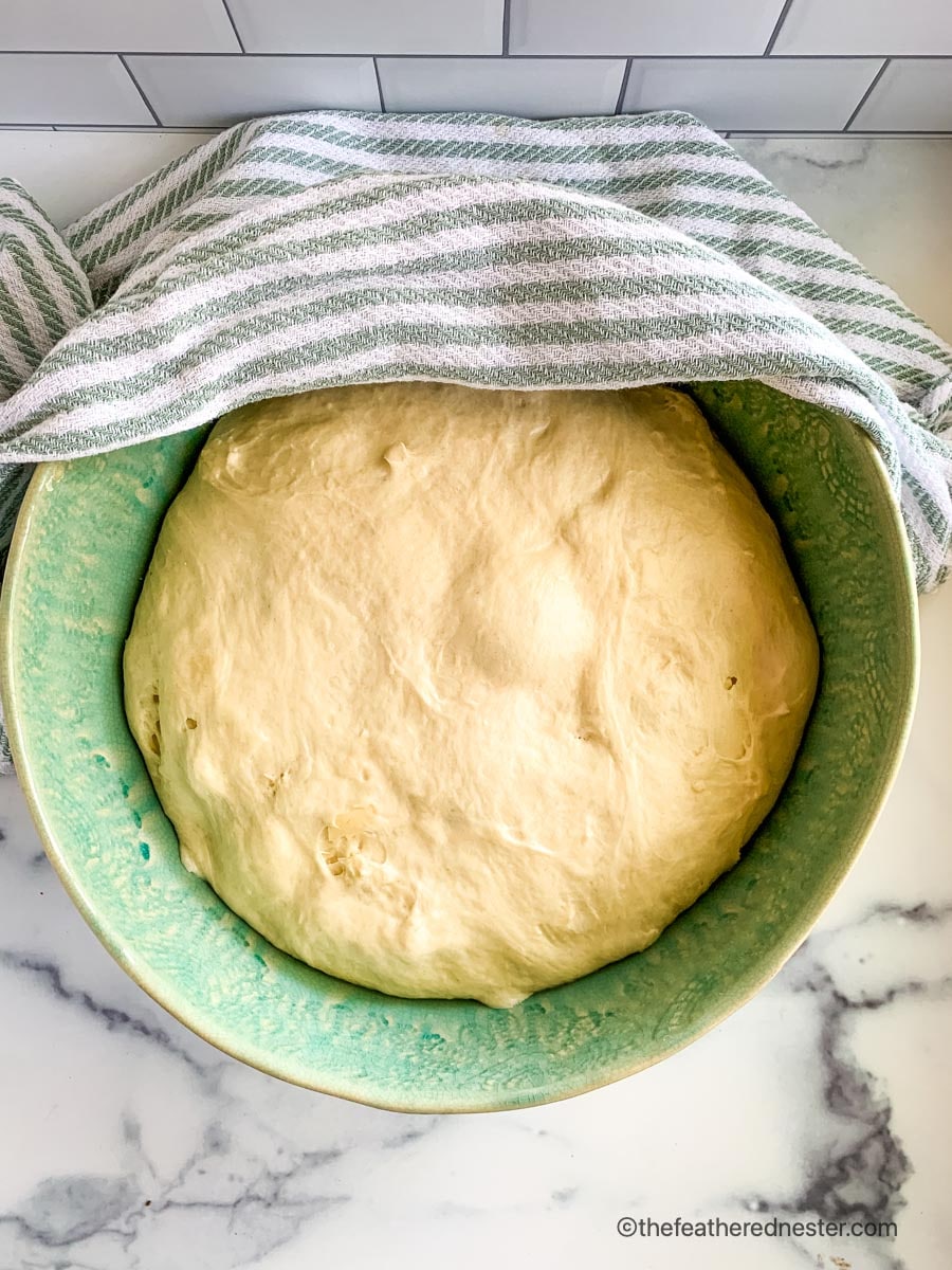 A bowl of risen bread dough.