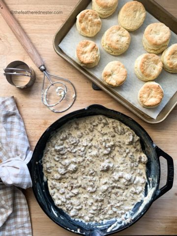 a cast iron skillet of sausage gravy and homemade biscuits.