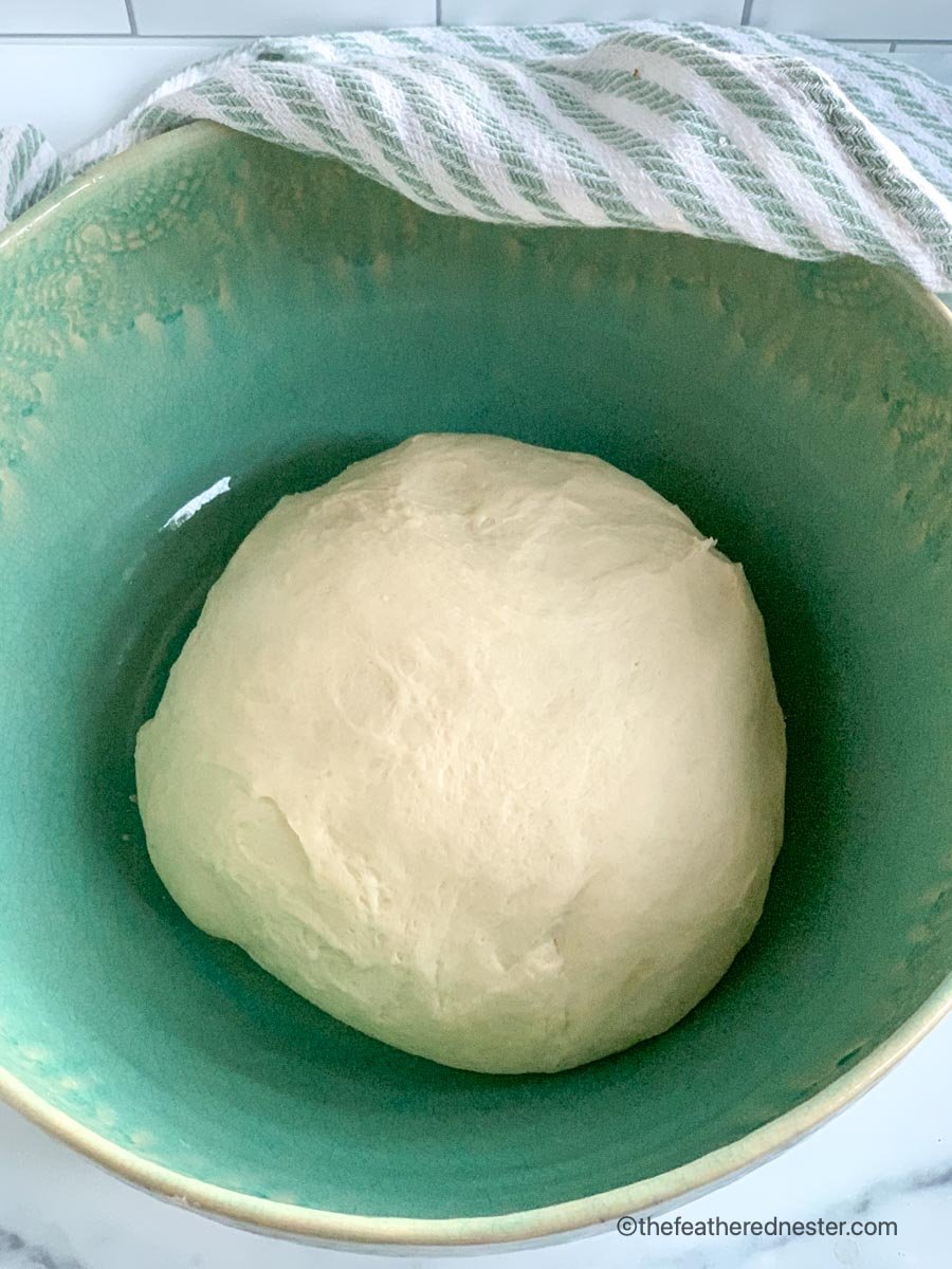 Bread dough fermenting in a bowl.