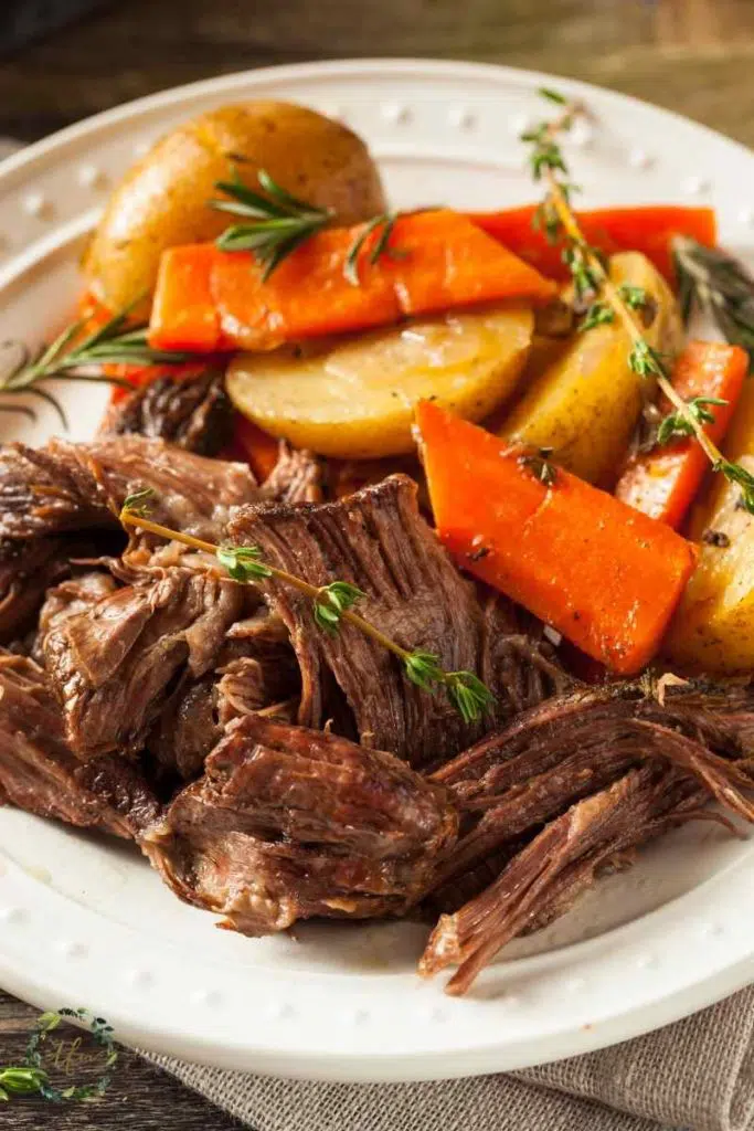 plate of pot roast chuck roast with carrots and potatoes