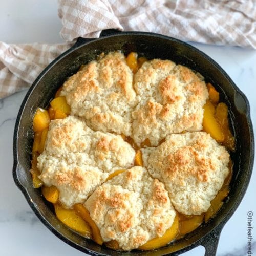 a cast iron skillet with peach cobbler.