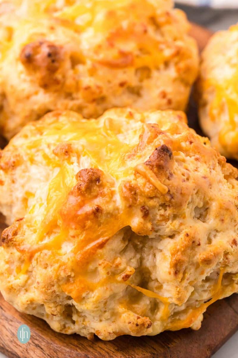 Cheddar biscuits on a wooden platter.