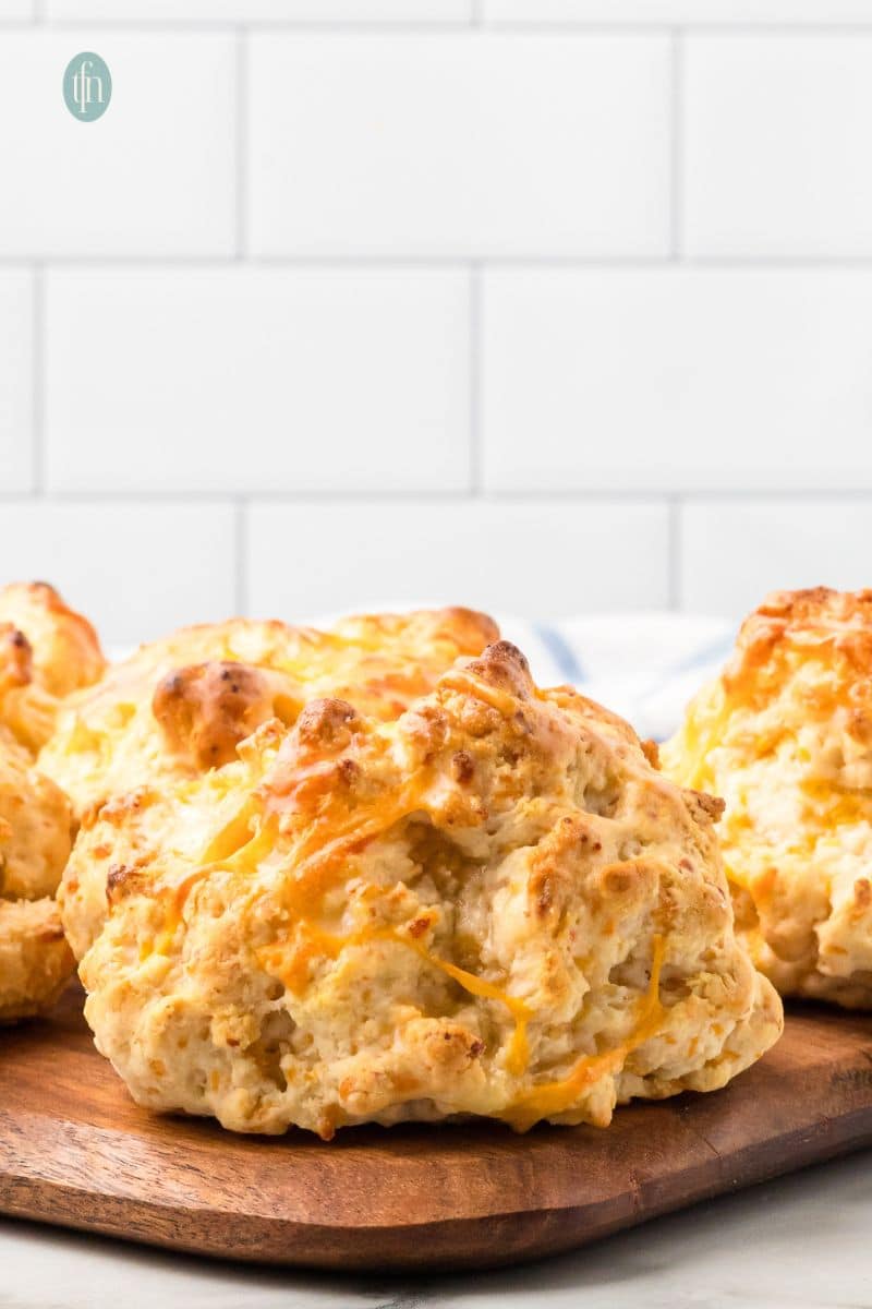 Cheddar biscuits on a wooden platter.