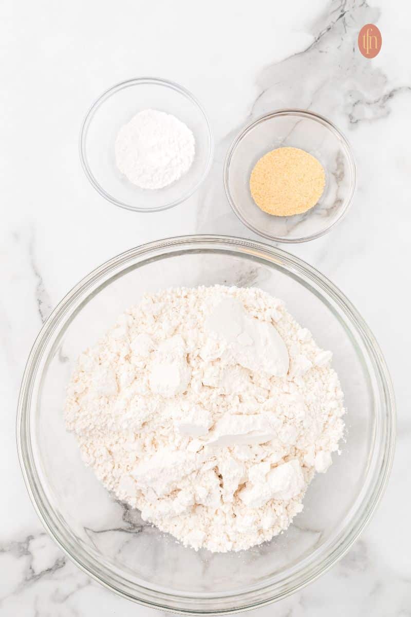 A bowl of flour, baking powder, and garlic powder.