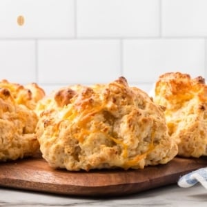 Cheddar biscuits on a wooden platter.