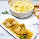 a platter or turkey tenderloin breasts and a bowl of mashed potatoes