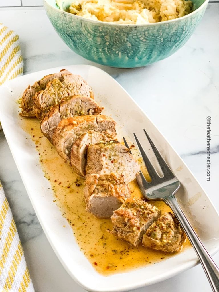 a platter of instant pot pork tenderloin sliced and ready to serve.