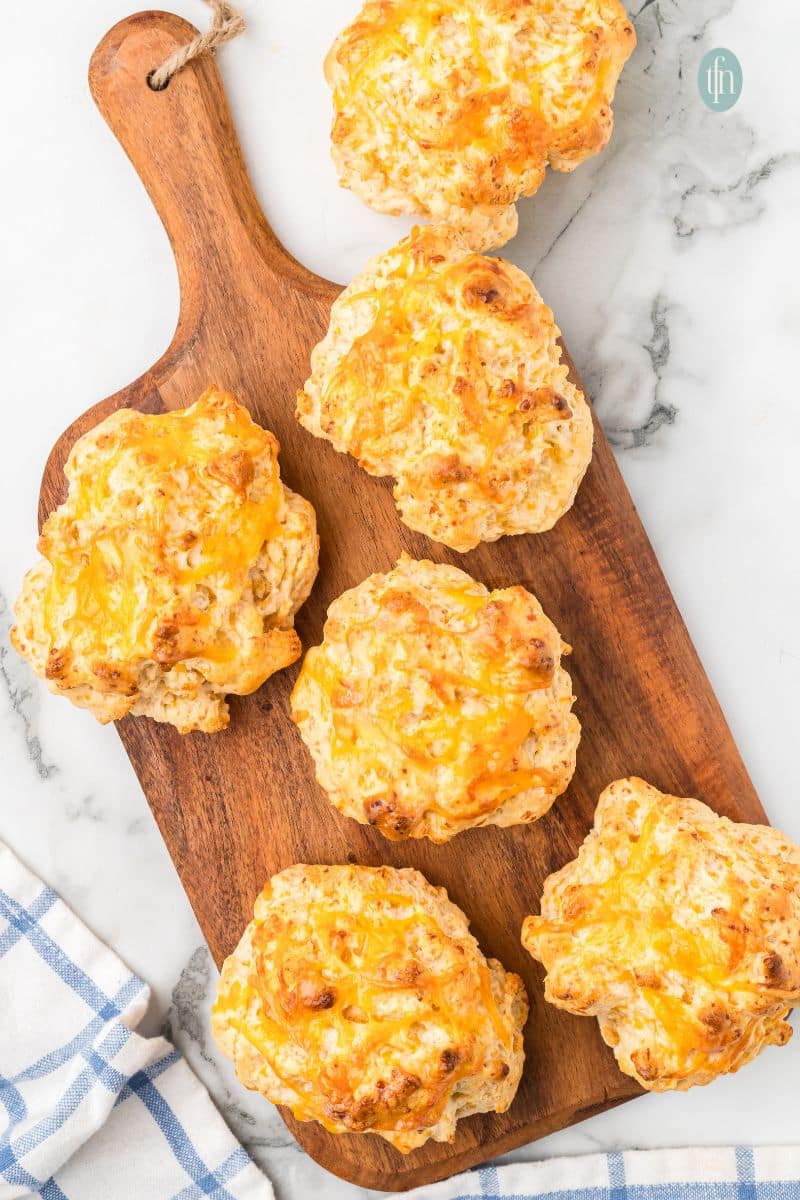 Cheddar biscuits on a wooden platter.