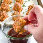 dipping a sausage ball into a dipping sauce