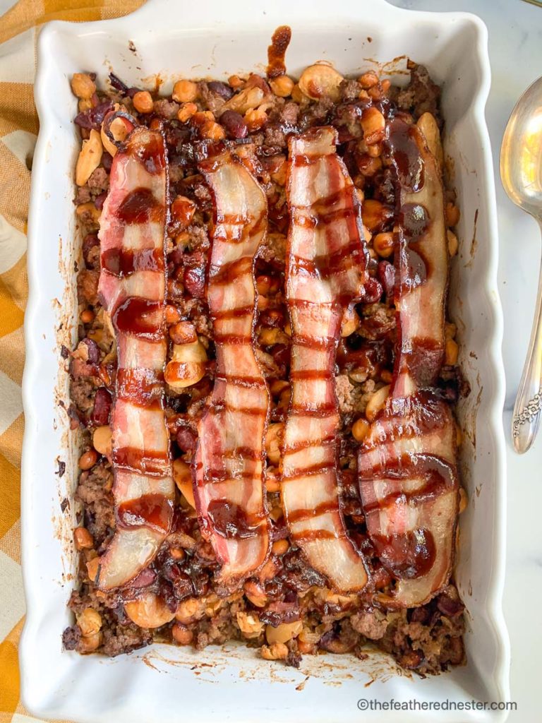 a casserole dish of baked calico beans with bacon
