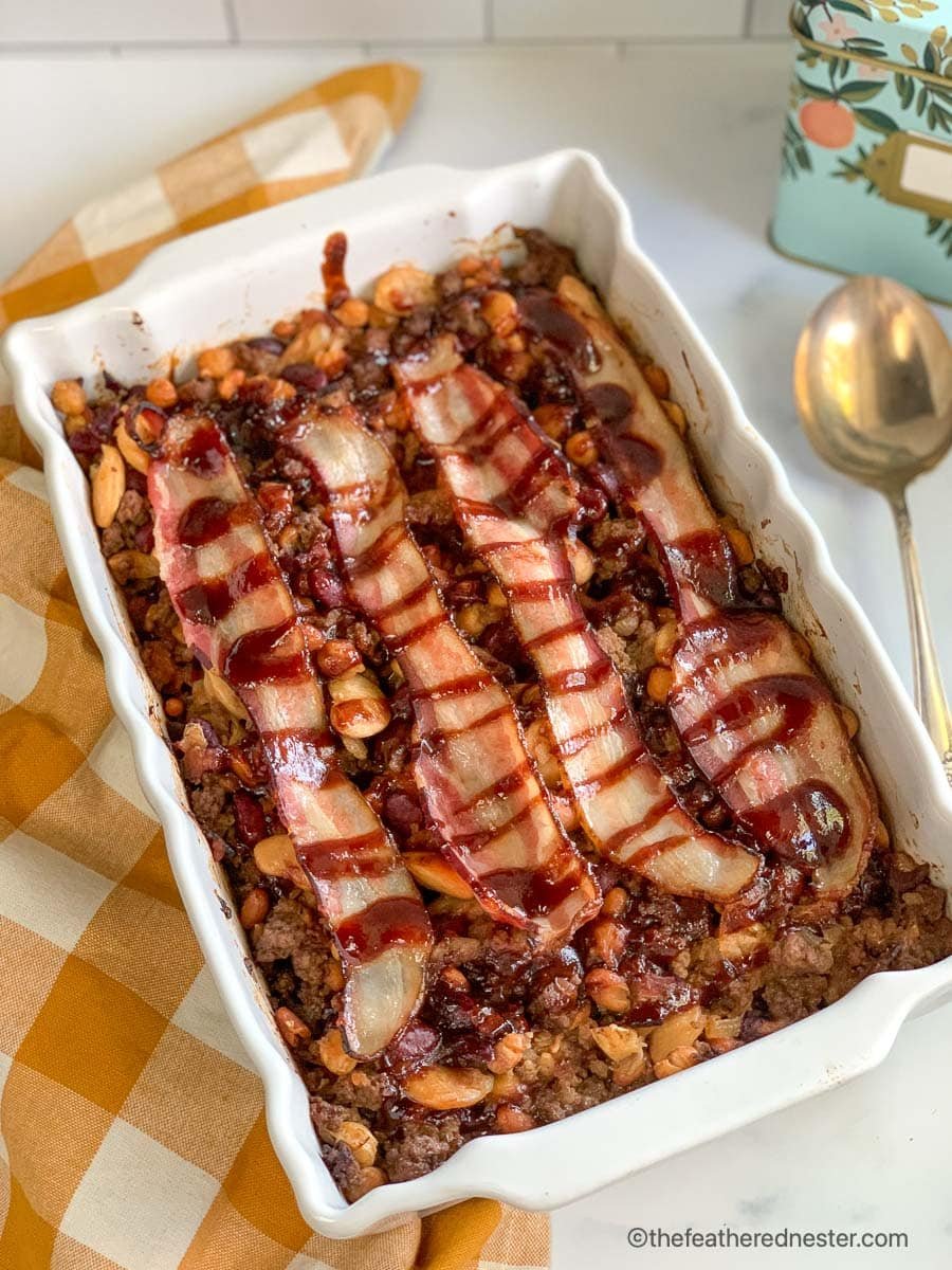 A casserole dish of calico beans with bacon.