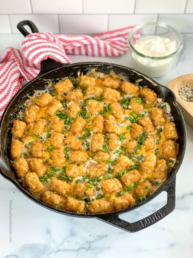 Skillet of green bean casserole with tater tots and hamburger.