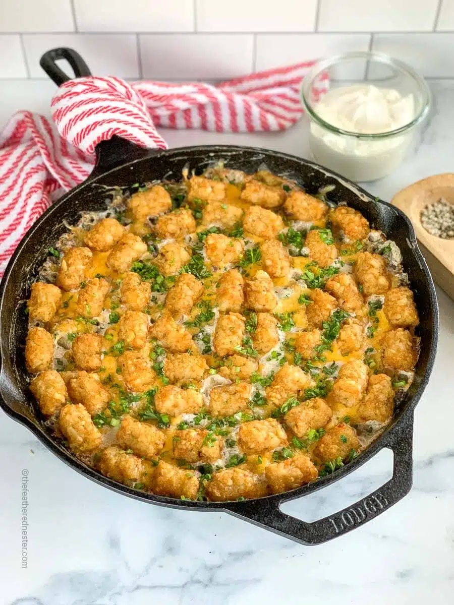 Skillet of green bean casserole with tater tots and hamburger.