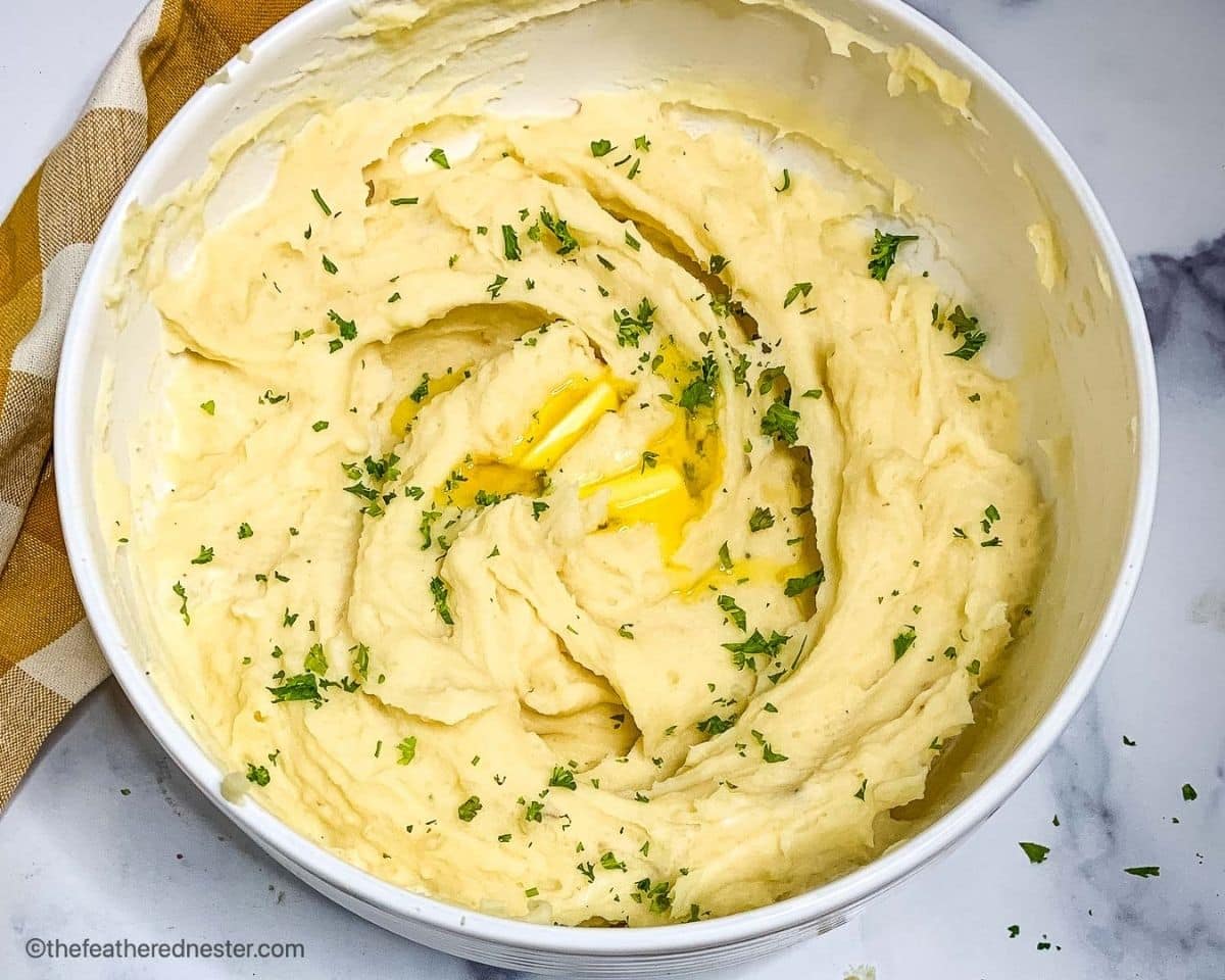 Fluffy and buttery russets side dish in a white bowl.