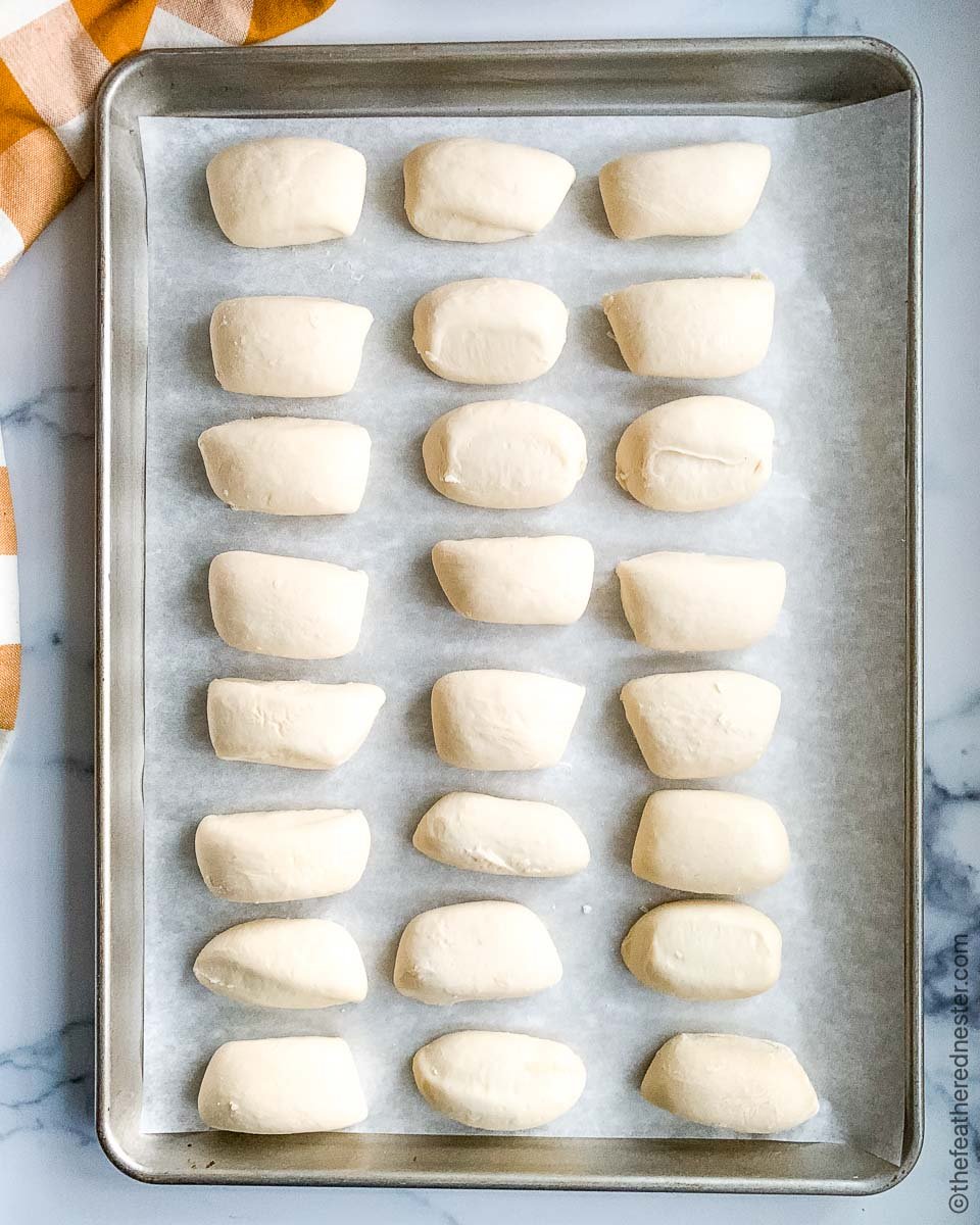 A baking sheet of yeast bread roll dough, ready to bake.