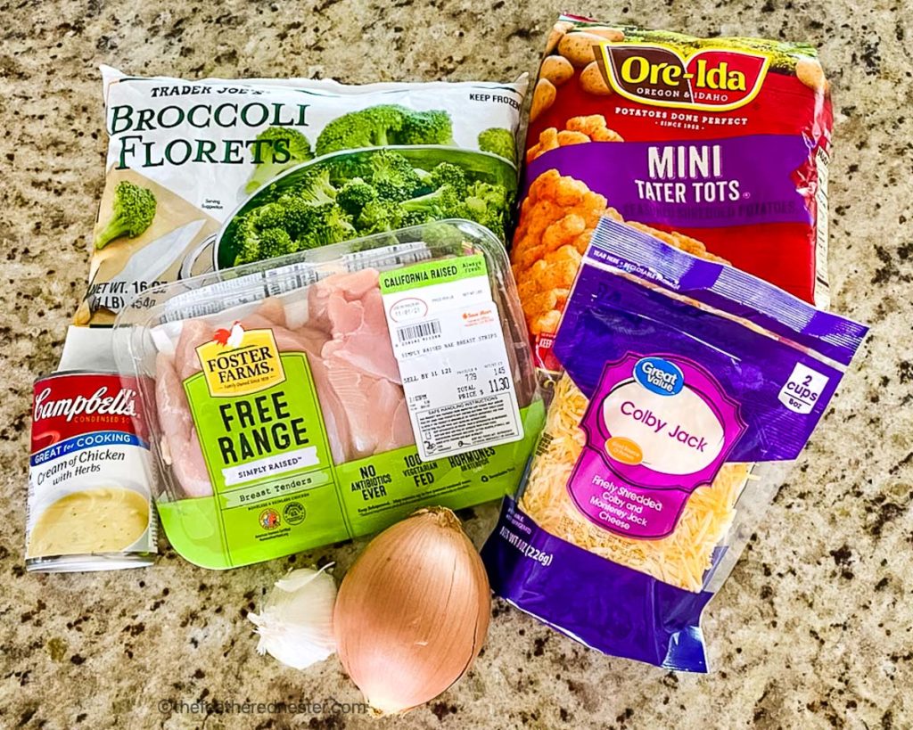 Packages of ingredients on a marble countertop to make chicken broccoli and potatoes.