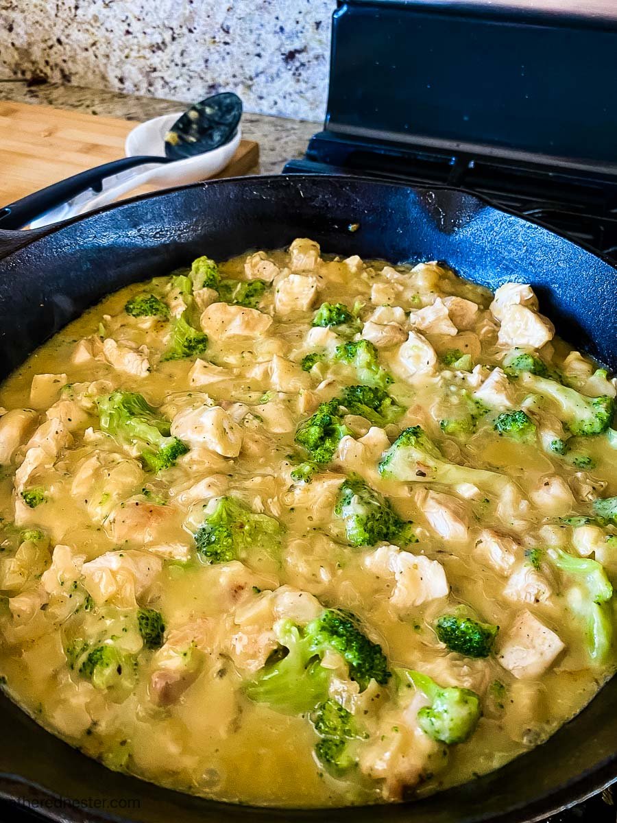 sautéing chicken and broccoli in a cast iron skillet