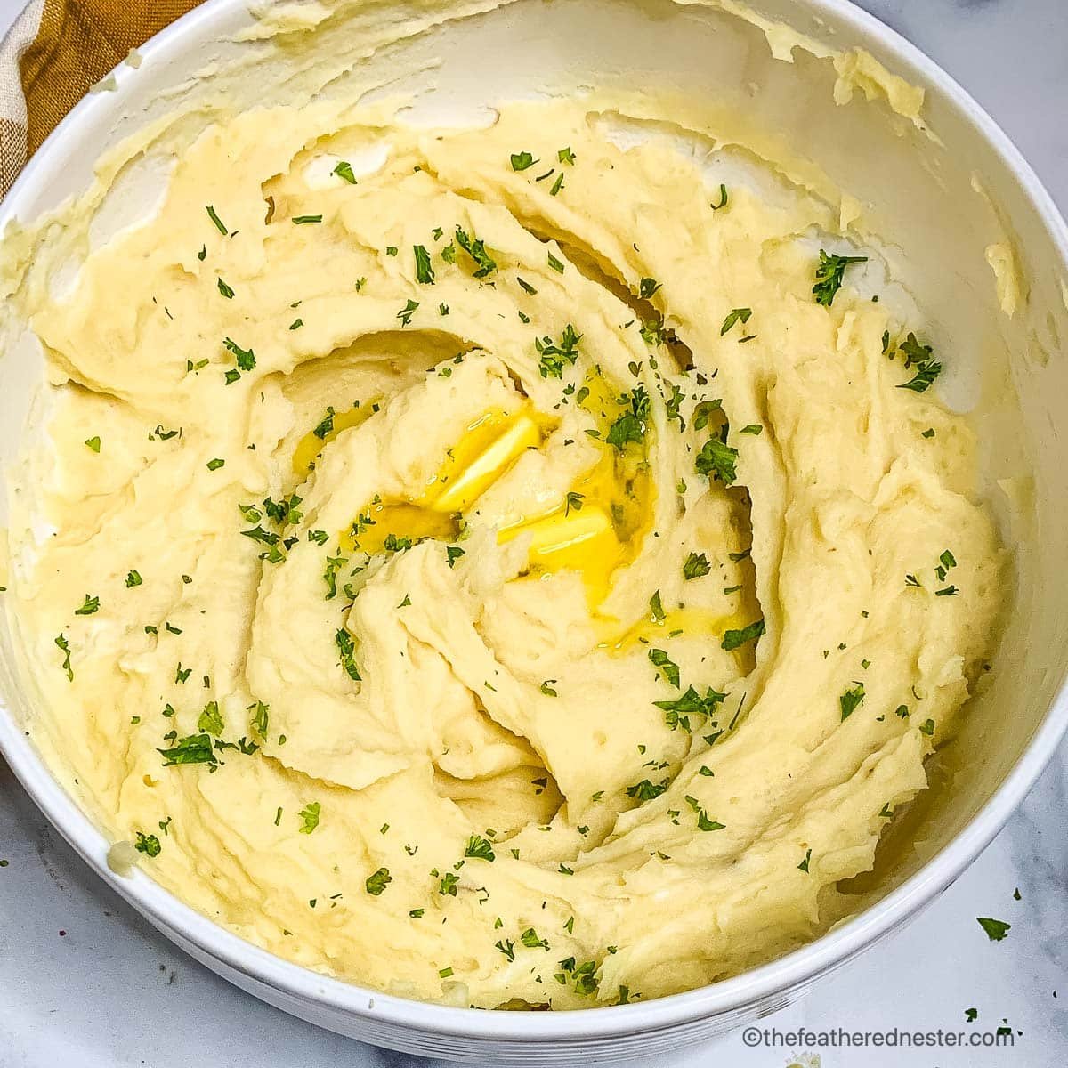 a bowl of garlic and butter mashed potatoes.