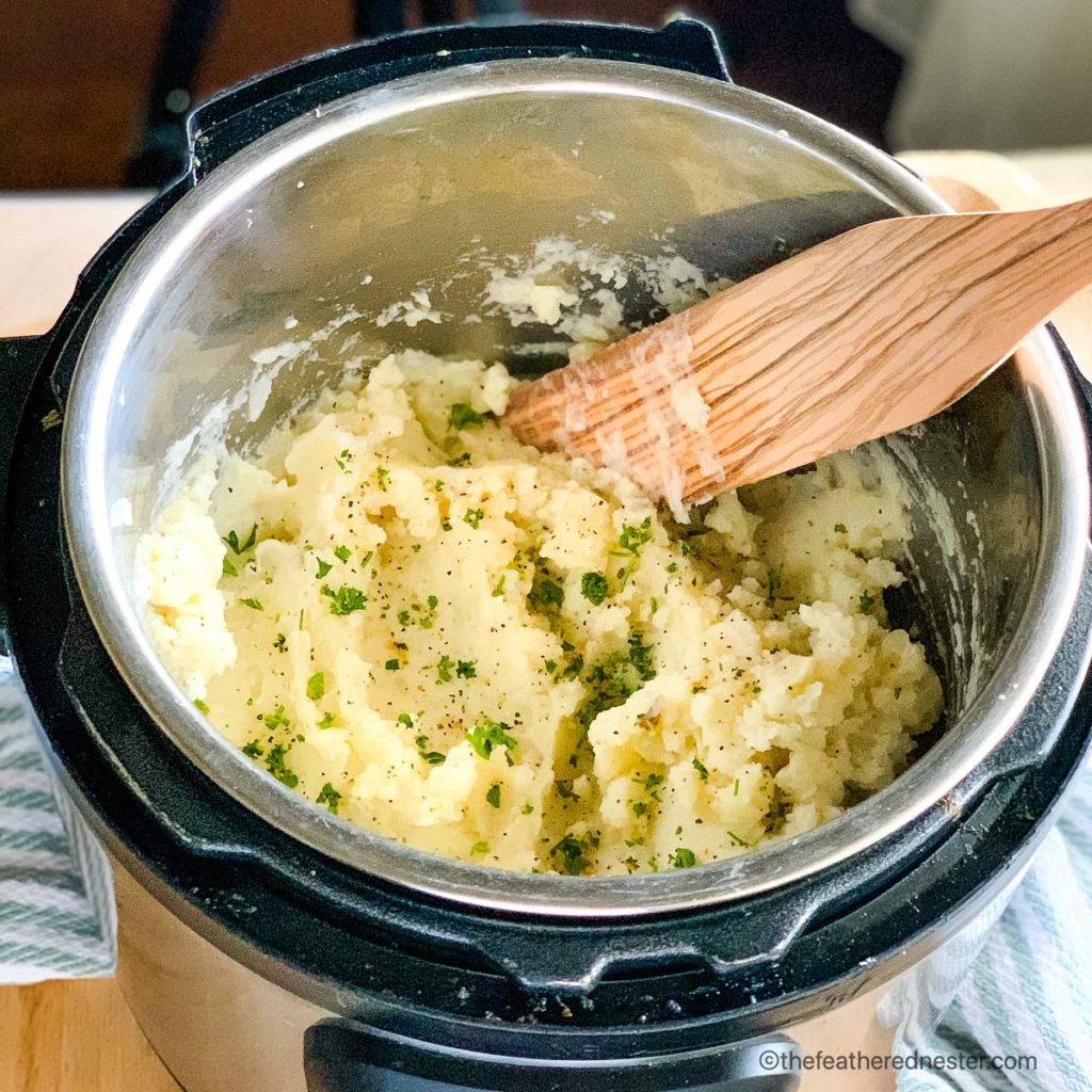 a pot of mashed potatoes with butter and garlic