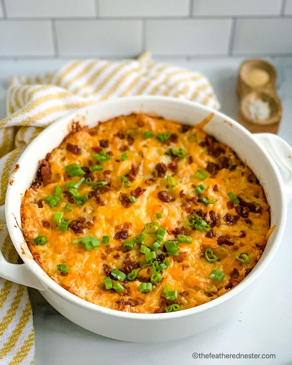 a casserole dish of loaded Hashbrown Casserole ready to serve.