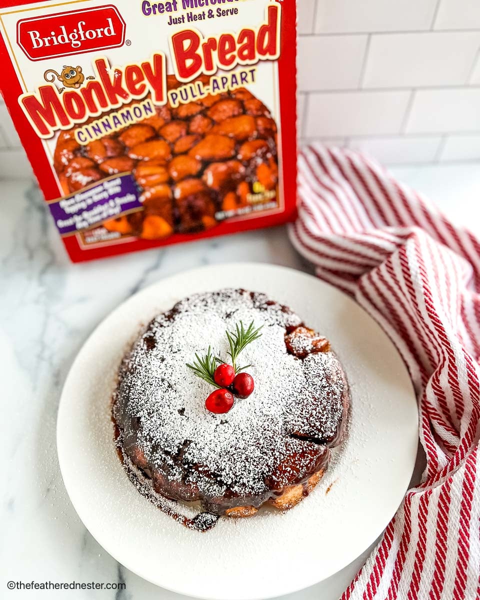 a plate of Monkey Bread Cinnamon Pull-Apart with a box of Bridgford frozen Monkey in the background.