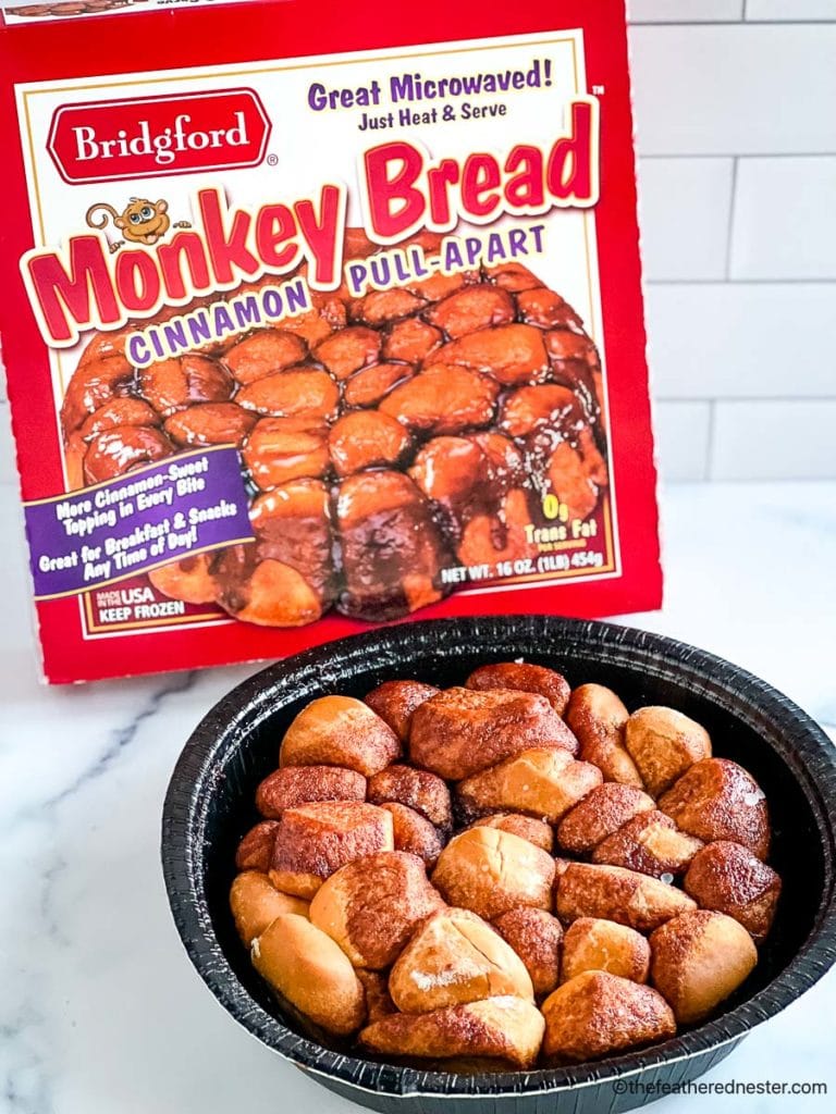 an oven ready container of monkey bread with a container of monkey bread in the background