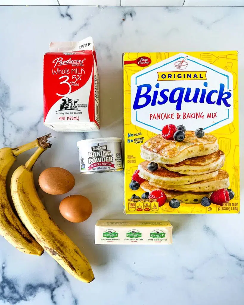 ingredients for banana pancakes: Bisquick, two bananas, milk, butter, and two eggs