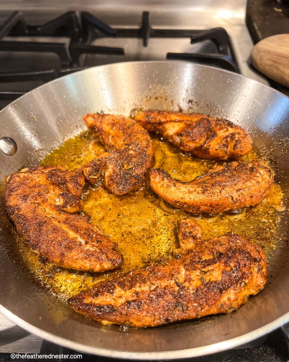 photo shows how to blacken chicken in a cast iron skillet.