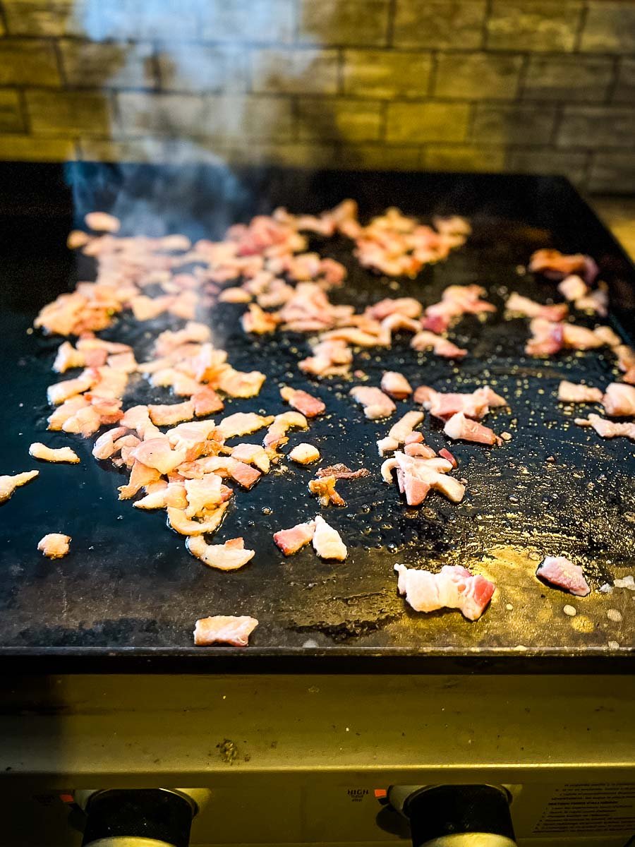 bacon cooking on the griddle.