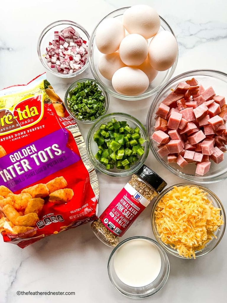 ingredients for this tater tot casserole recipe: tater tots, diced ham, shredded cheese, all purpose seasoning, cream, eggs, diced onion, chopped green onions, diced bell pepper