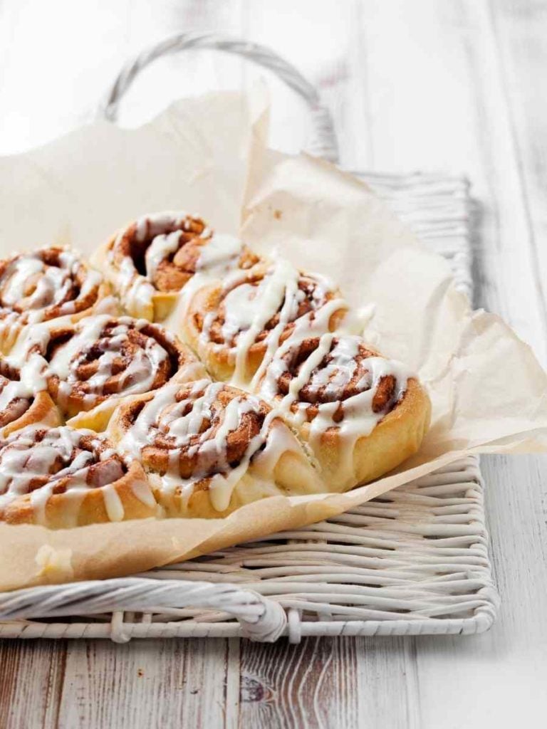 a baking sheet of frosted cinnamon rolls