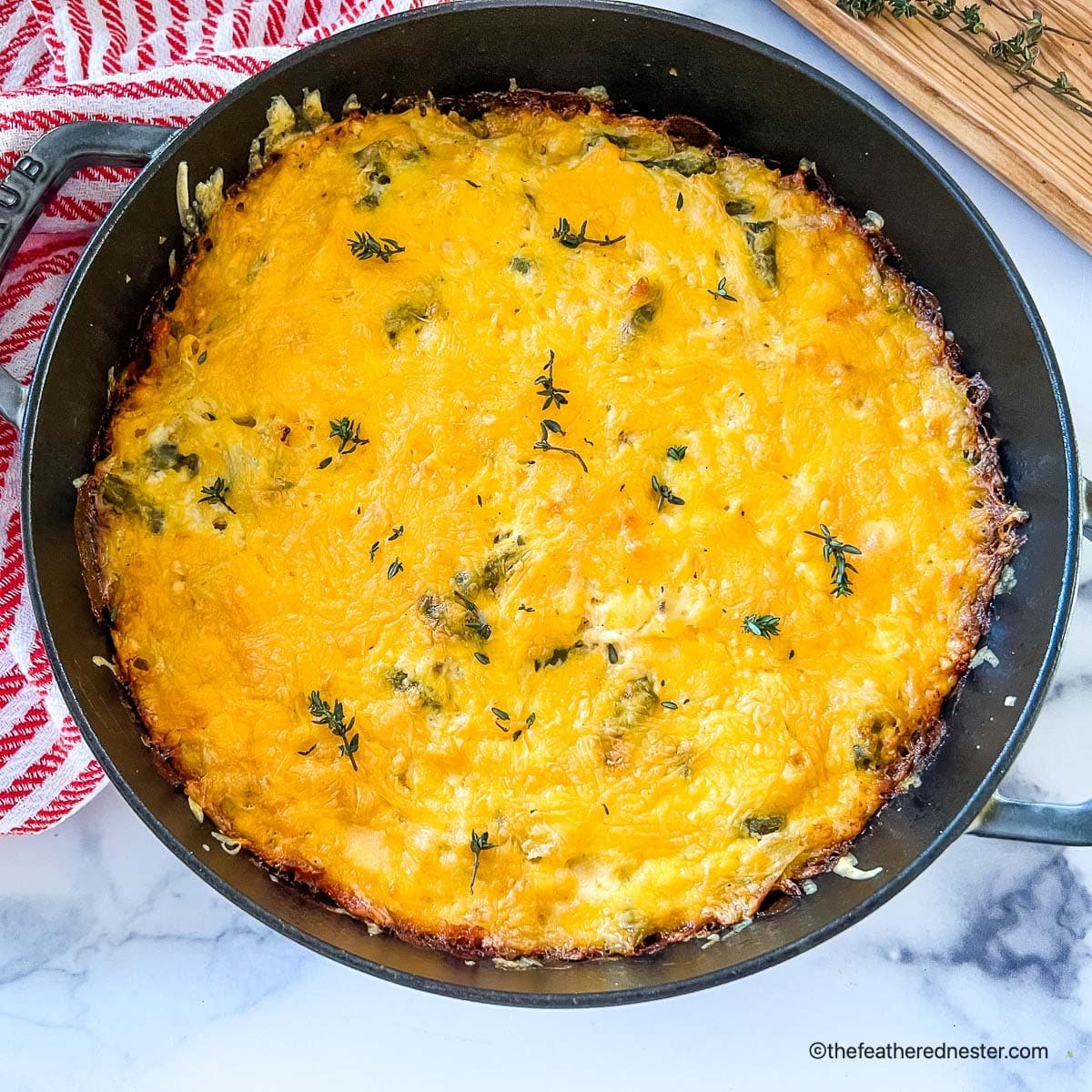 a skillet of hash brown casserole ready to serve.