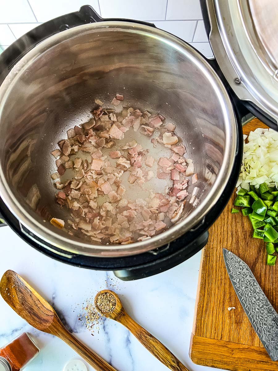 Sauteing bacon in a pressure cooker.