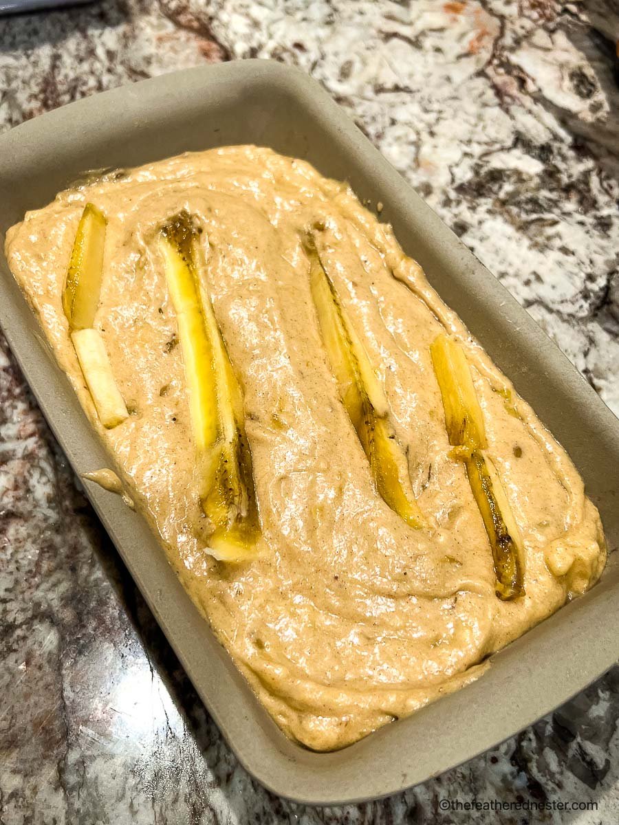 bread mixture in a pampered chef stone loaf pan ready to bake.