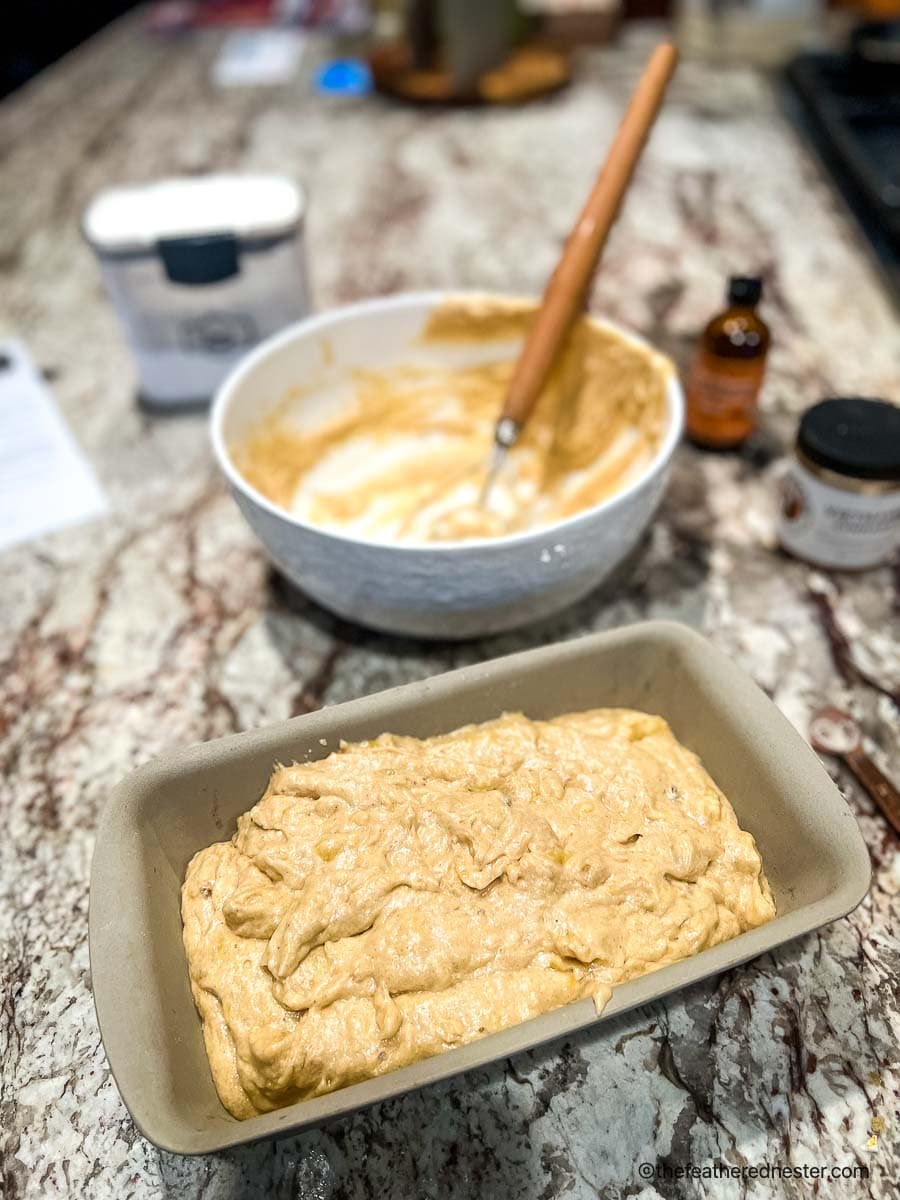 Mixed sourdough starter banana bread recipe poured into a loaf pan.