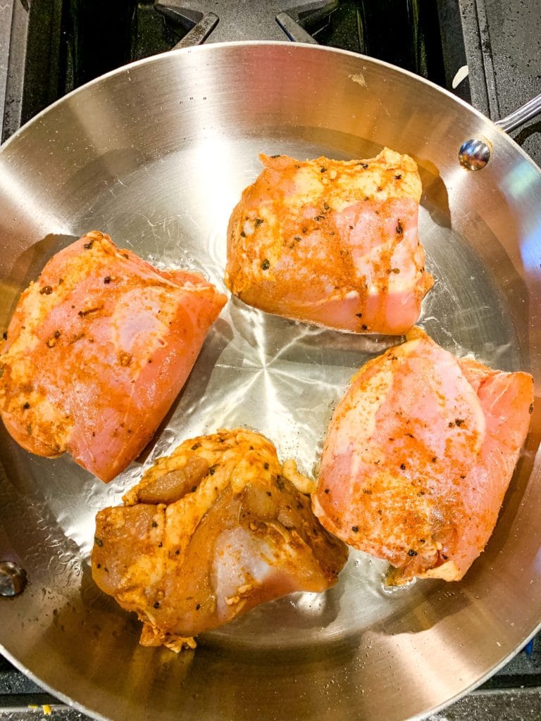 searing chicken thighs in a skillet