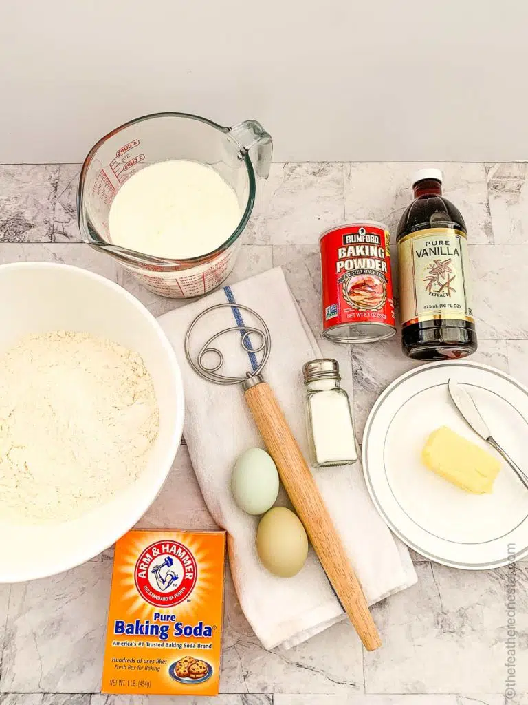 ingredients for pancakes along with a dough whisk