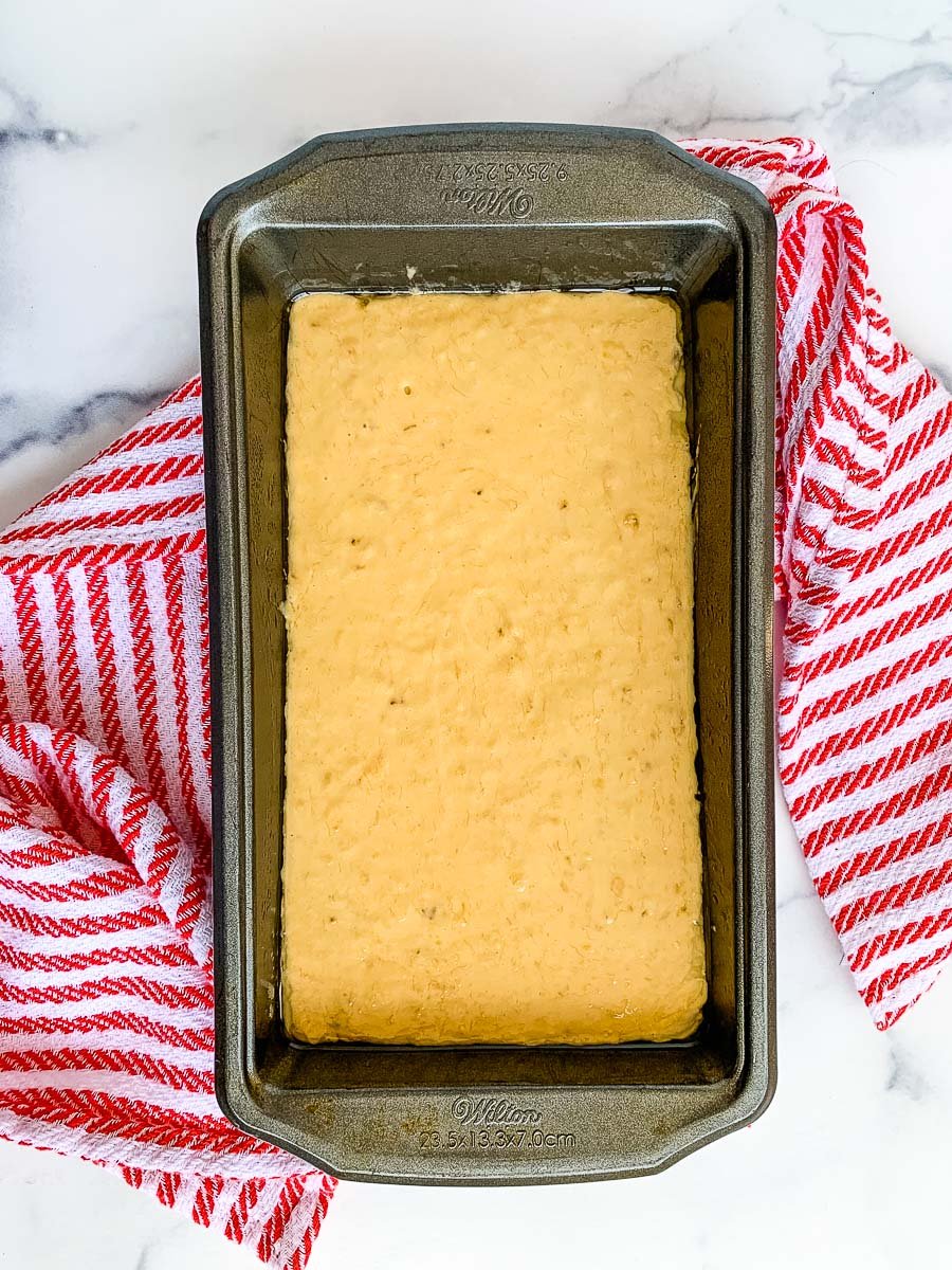 A loaf pan with banana nut bread with self rising flour batter ready to bake.