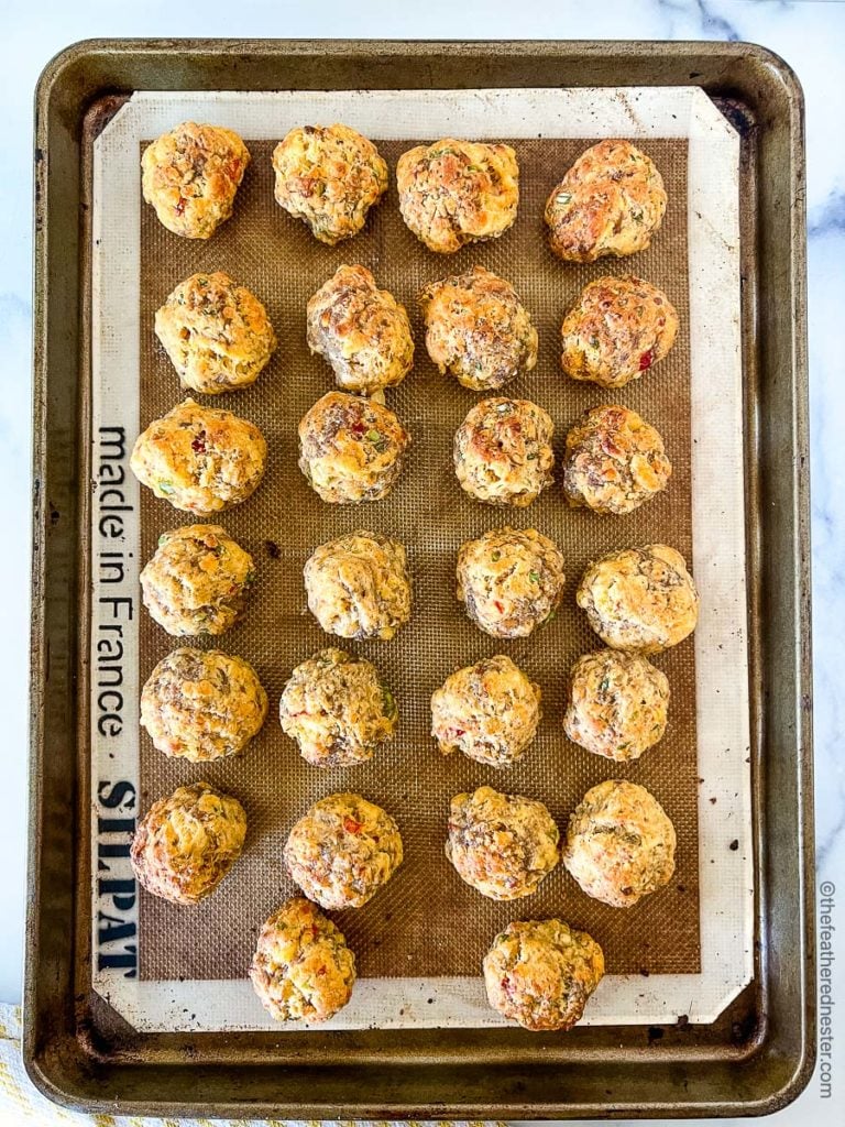 baked sausage balls with pimento cheese on a baking sheet